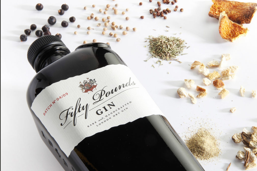 Fifty Pounds Gin – botanicals with bottle – Fifty Pounds Gin.